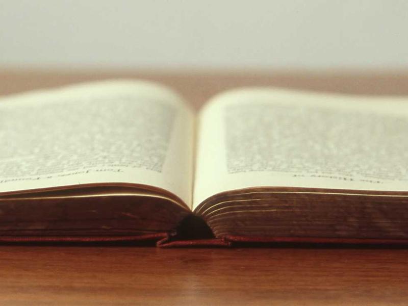 A high-tech server room bathed in neon blue light showing rows of supercomputers processing data